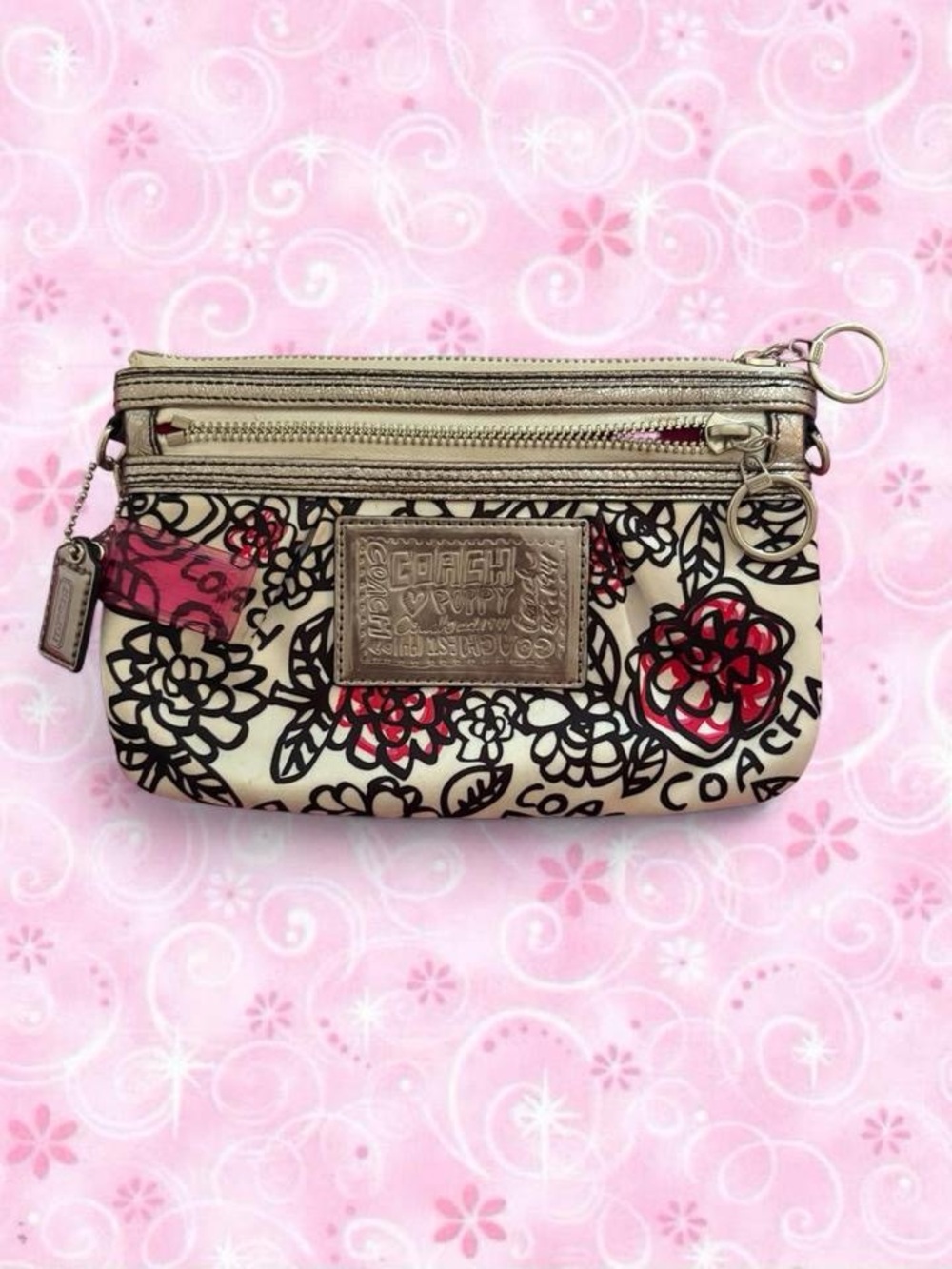 COACH Cream Floral Wristlet with Red and Black Accents